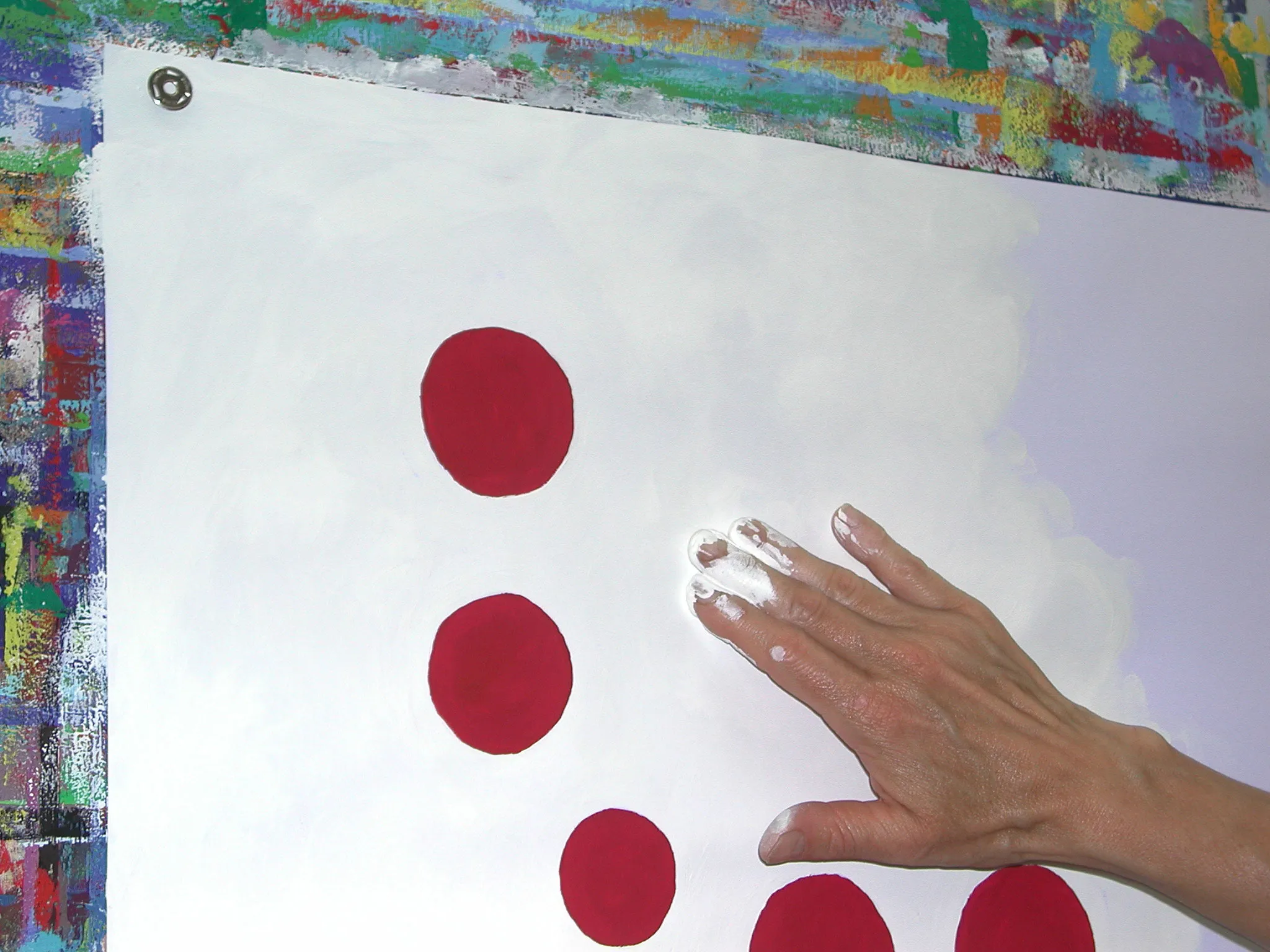 Hand malt rote Kreise auf Papier an der Wand